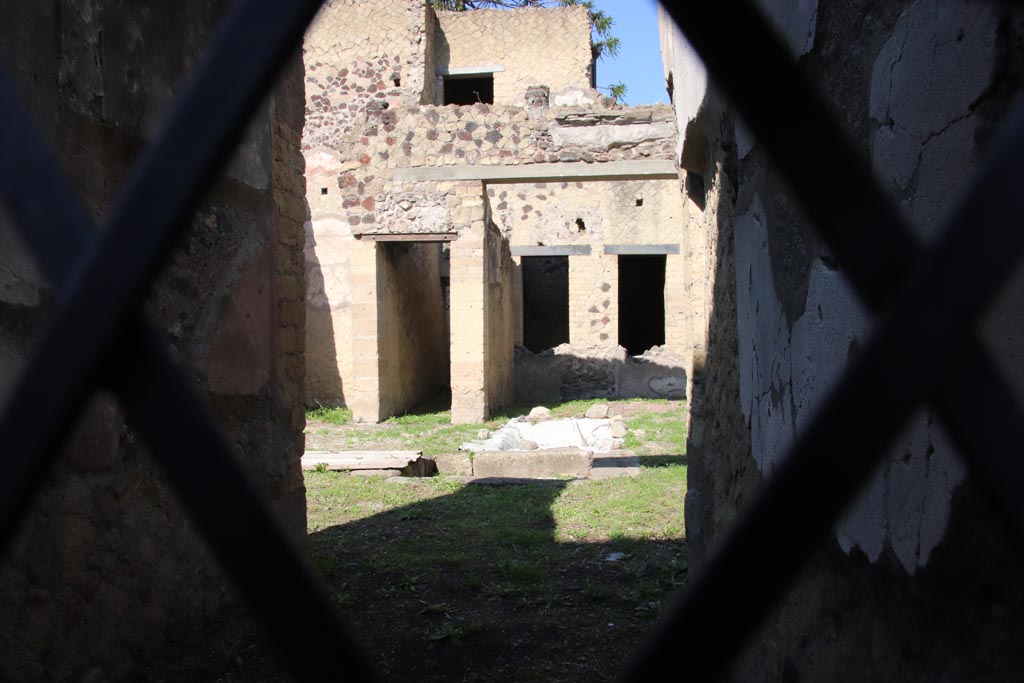 V.31 Herculaneum, October 2022. 
Looking west through entrance doorway towards atrium, tablinum, and corridor to rear rooms.  Photo courtesy of Klaus Heese.
